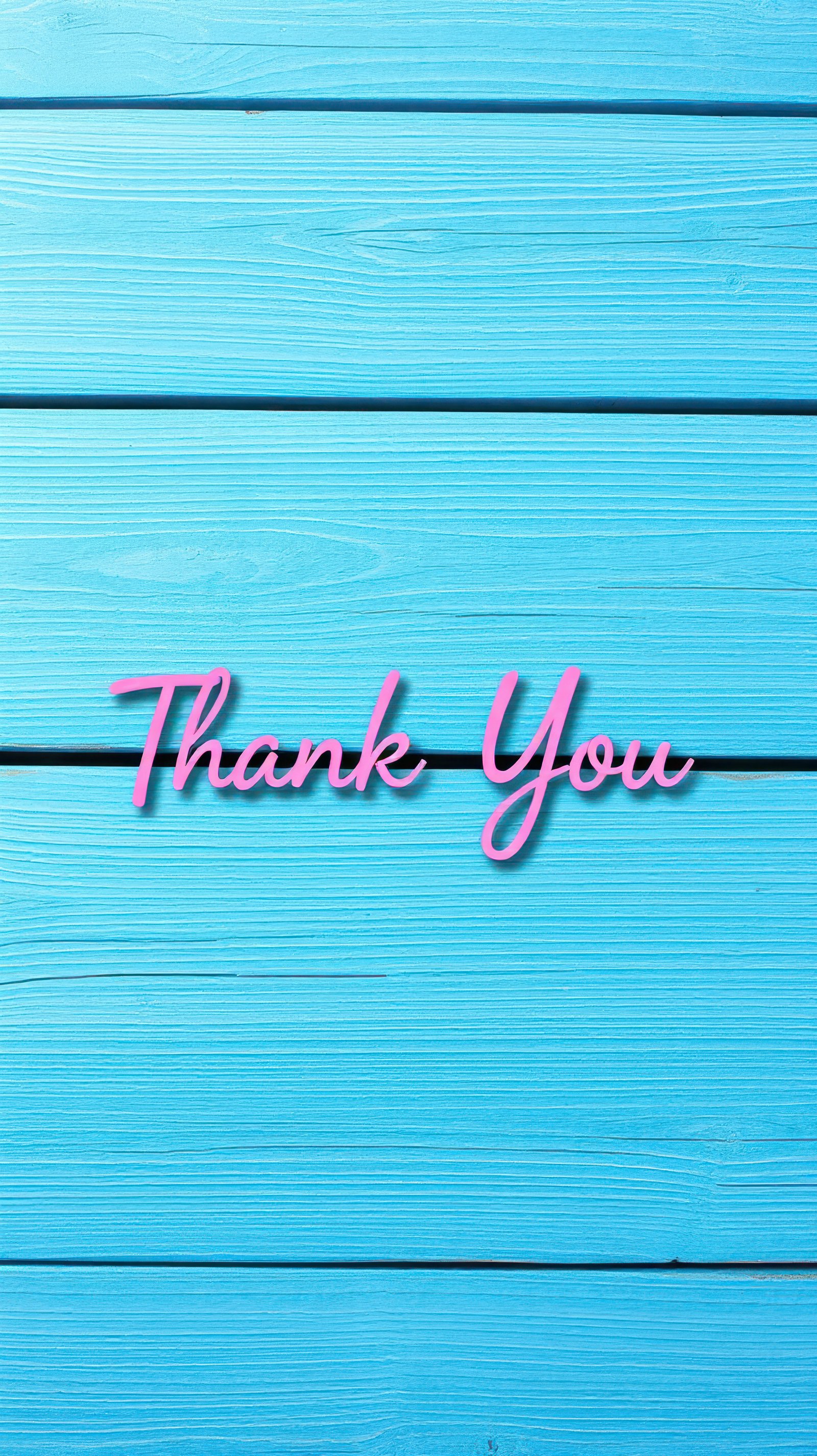 Bright blue wooden background with a pink handwritten thank you message for appreciation moments